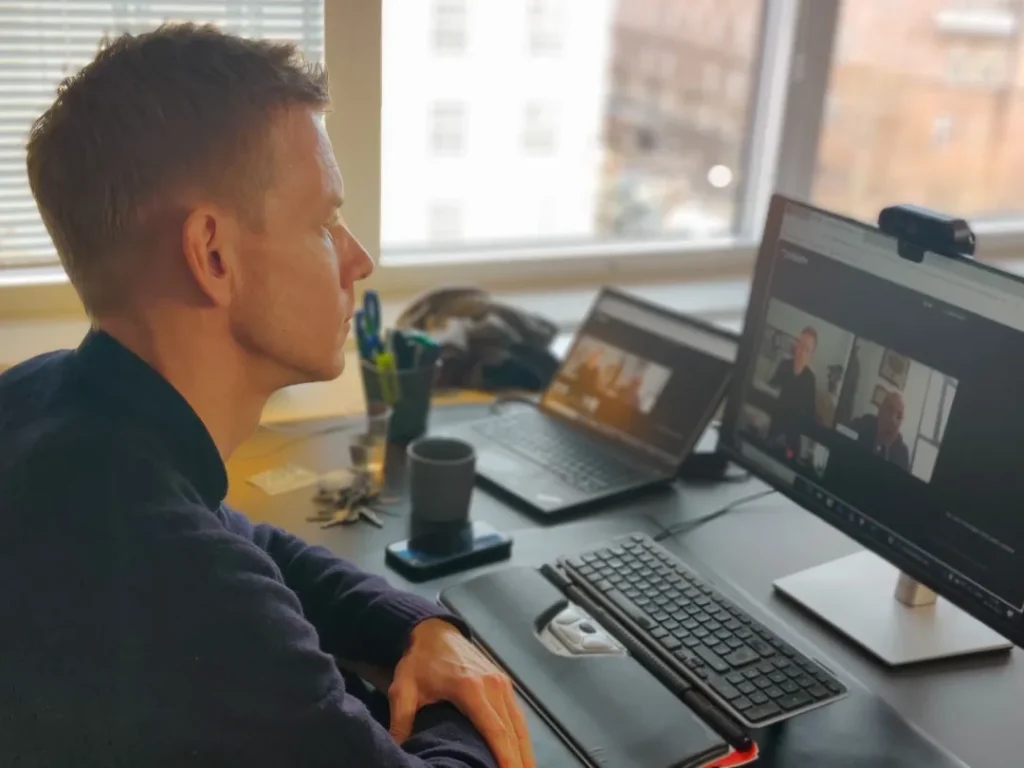 CEO Rasmus Grue Christensen in front of his computer