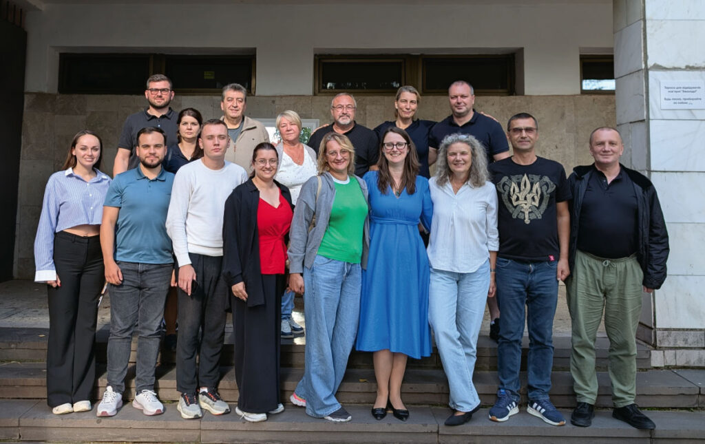 15 participants from DIGNITY’s partner organizations standing together looking into the camera